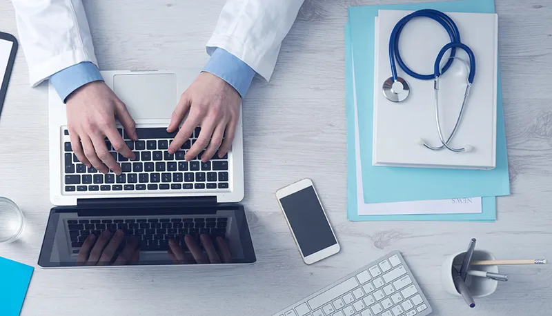 join-the-directory Menopause Doctor making bioidentical hormone replacement therapy notes on laptop